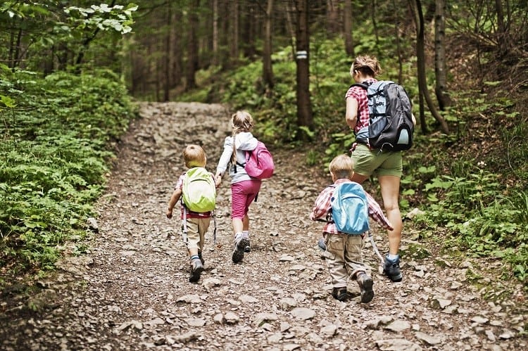 three kids and mom on trail