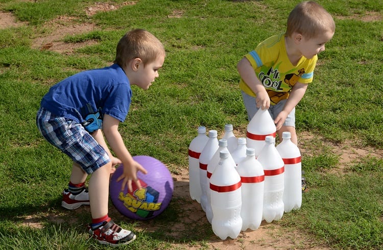 kids playing bottle bowling