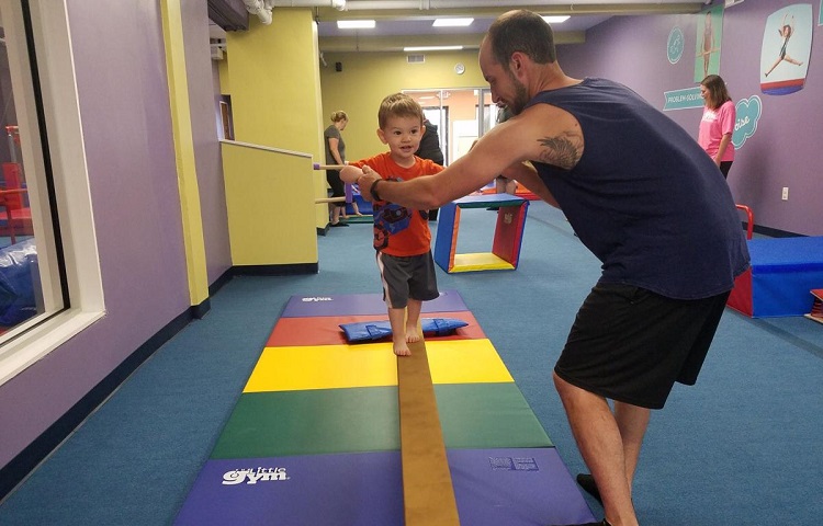 little boy learn to walk on balance bar